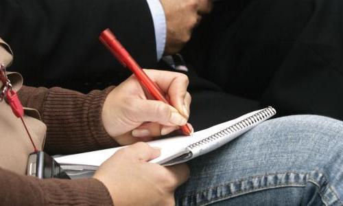 Reporter writing in notebook